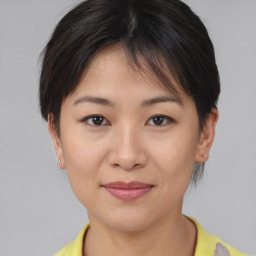 Joyful asian young-adult female with short  brown hair and brown eyes