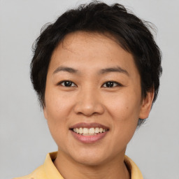 Joyful asian young-adult female with short  brown hair and brown eyes