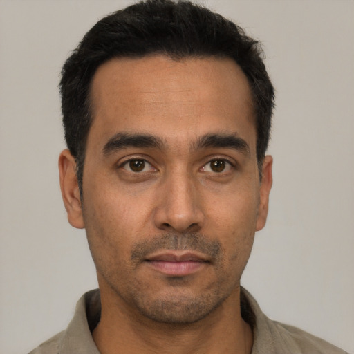 Neutral latino young-adult male with short  black hair and brown eyes