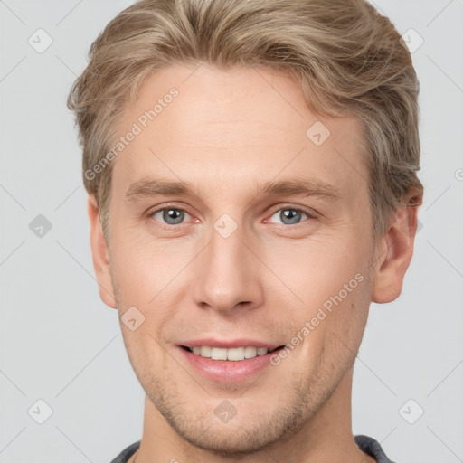 Joyful white young-adult male with short  brown hair and grey eyes