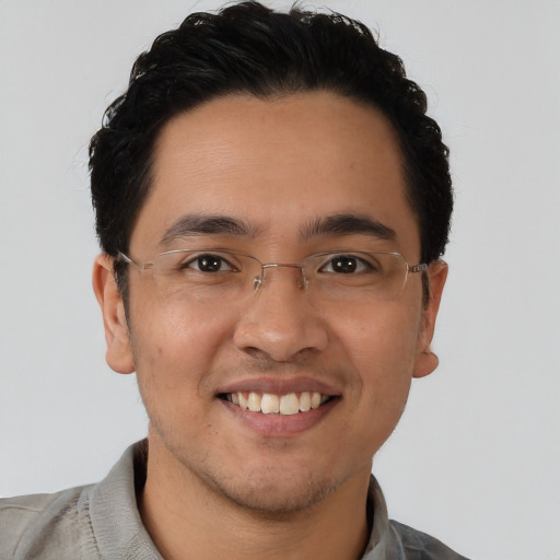 Joyful latino young-adult male with short  brown hair and brown eyes