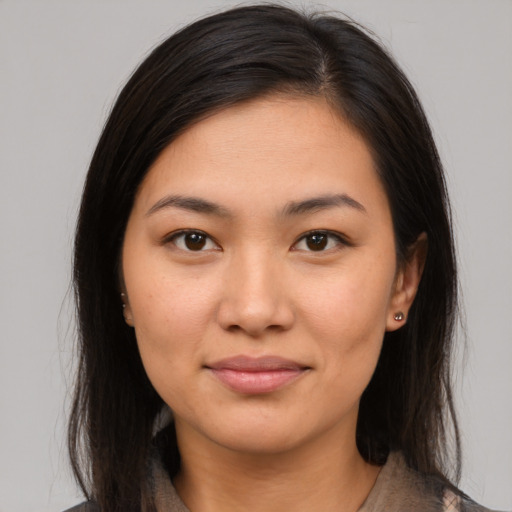 Joyful latino young-adult female with medium  brown hair and brown eyes