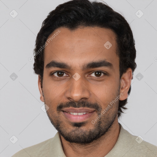 Joyful latino young-adult male with short  black hair and brown eyes