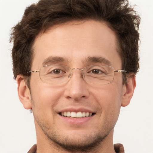 Joyful white adult male with short  brown hair and brown eyes