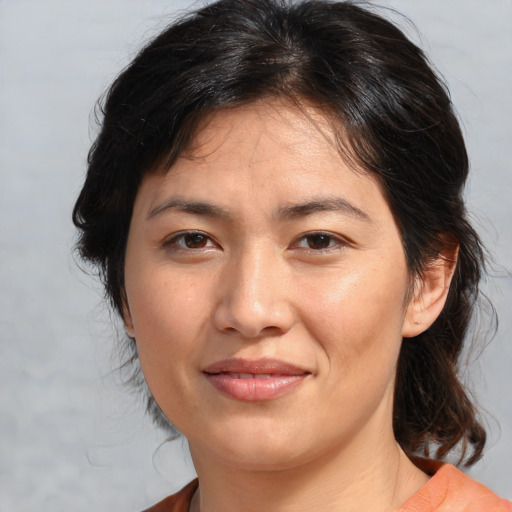 Joyful white adult female with medium  brown hair and brown eyes