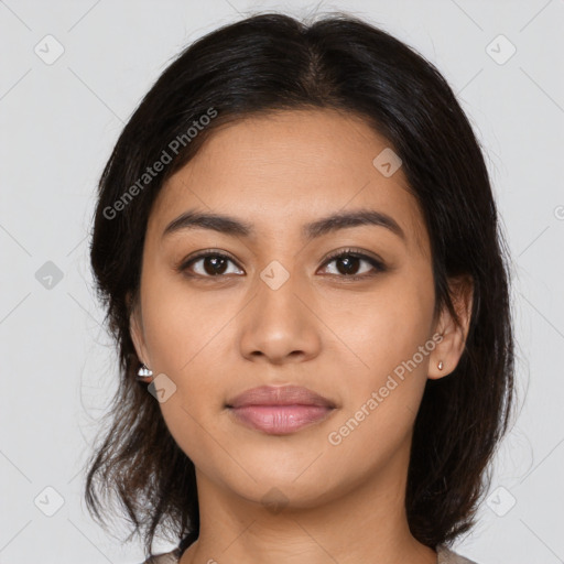 Joyful latino young-adult female with medium  brown hair and brown eyes