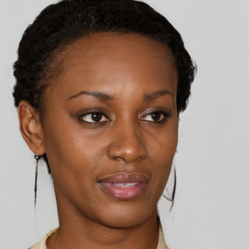 Joyful black young-adult female with short  brown hair and brown eyes