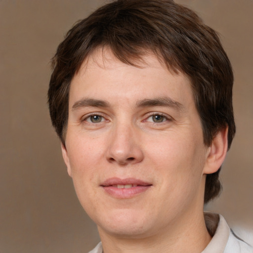 Joyful white adult male with short  brown hair and brown eyes