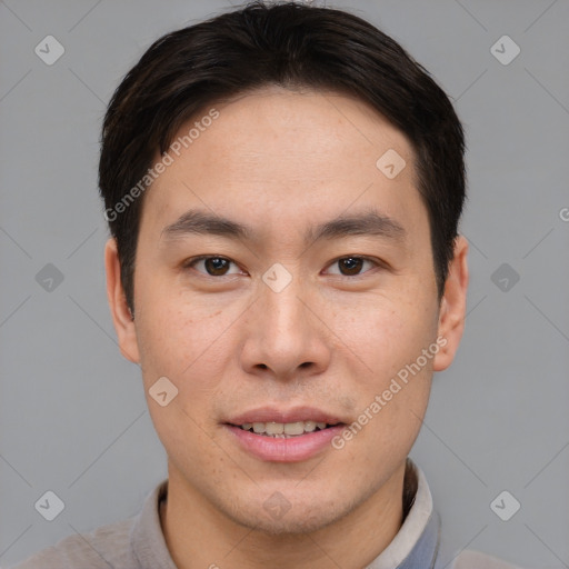 Joyful asian young-adult male with short  brown hair and brown eyes