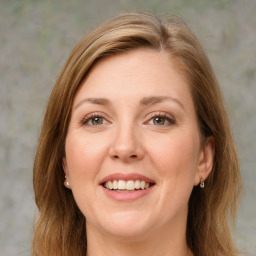 Joyful white young-adult female with medium  brown hair and green eyes