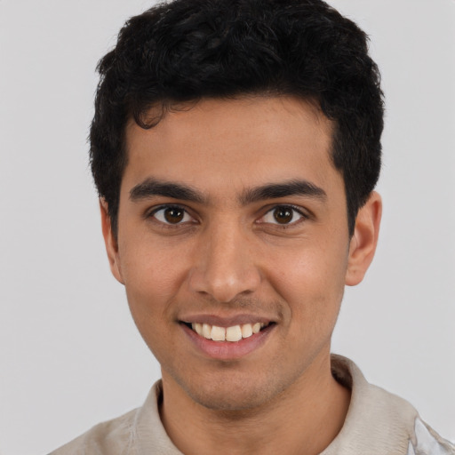 Joyful latino young-adult male with short  black hair and brown eyes