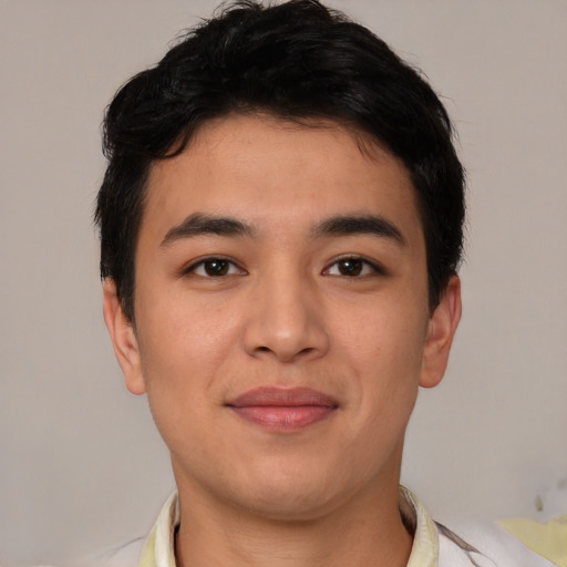 Joyful asian young-adult male with short  brown hair and brown eyes