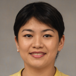 Joyful asian young-adult female with short  brown hair and brown eyes