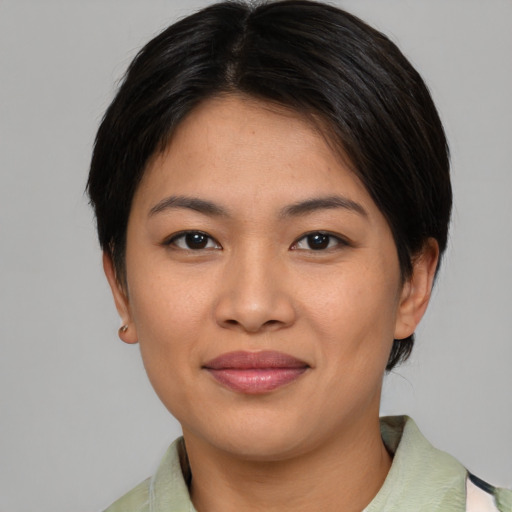 Joyful asian young-adult female with short  brown hair and brown eyes