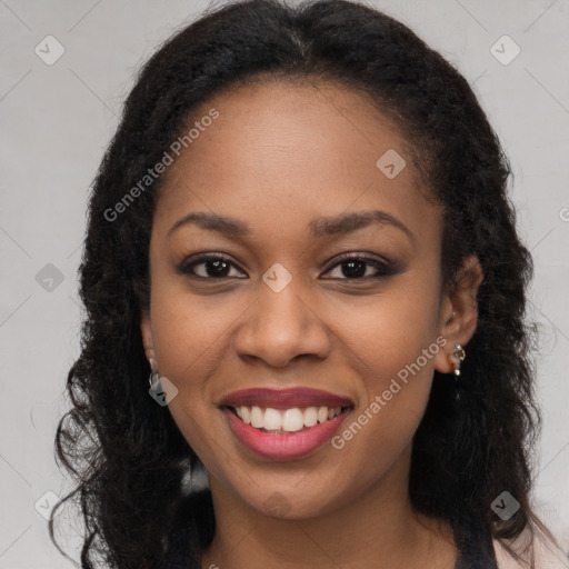 Joyful black young-adult female with long  brown hair and brown eyes