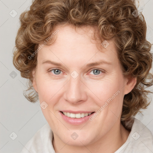 Joyful white young-adult female with medium  brown hair and blue eyes