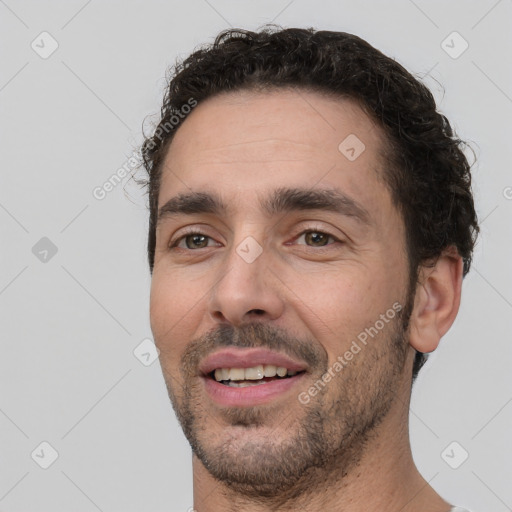 Joyful white young-adult male with short  black hair and brown eyes