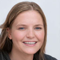 Joyful white young-adult female with long  brown hair and blue eyes