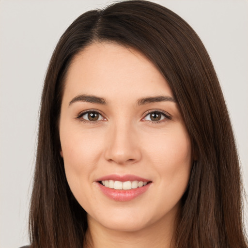 Joyful white young-adult female with long  brown hair and brown eyes