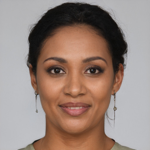 Joyful latino young-adult female with short  black hair and brown eyes