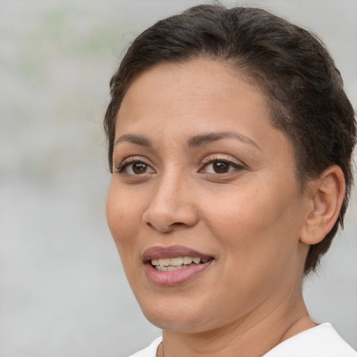 Joyful white adult female with short  brown hair and brown eyes