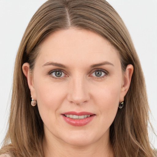 Joyful white young-adult female with long  brown hair and grey eyes