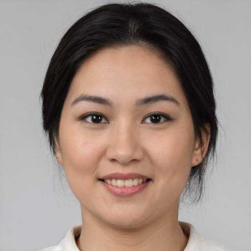 Joyful asian young-adult female with medium  brown hair and brown eyes