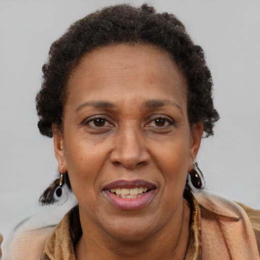 Joyful black adult female with short  brown hair and brown eyes