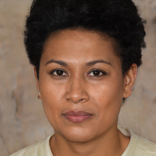 Joyful black adult female with short  brown hair and brown eyes