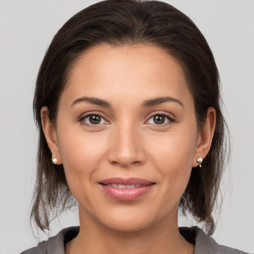 Joyful white young-adult female with medium  brown hair and brown eyes