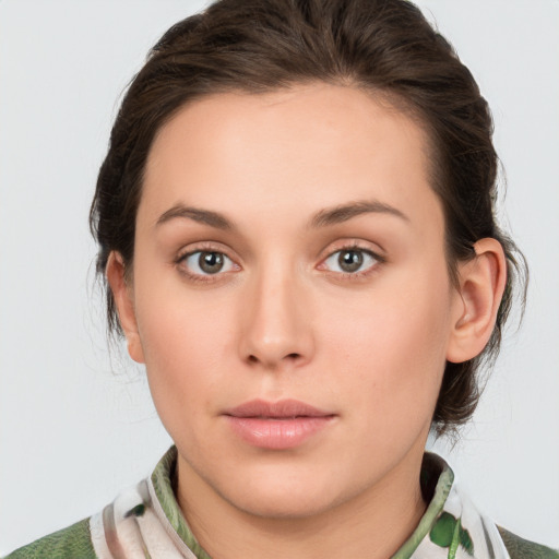 Neutral white young-adult female with medium  brown hair and green eyes