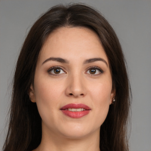 Joyful white young-adult female with long  brown hair and brown eyes