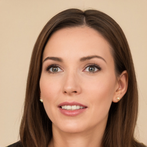 Joyful white young-adult female with long  brown hair and brown eyes