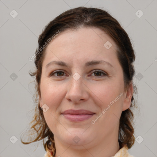 Joyful white adult female with medium  brown hair and brown eyes