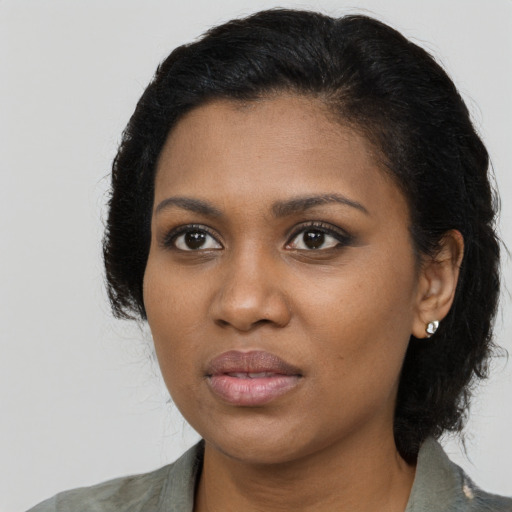 Joyful black young-adult female with medium  black hair and brown eyes