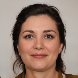 Joyful white adult female with medium  brown hair and brown eyes