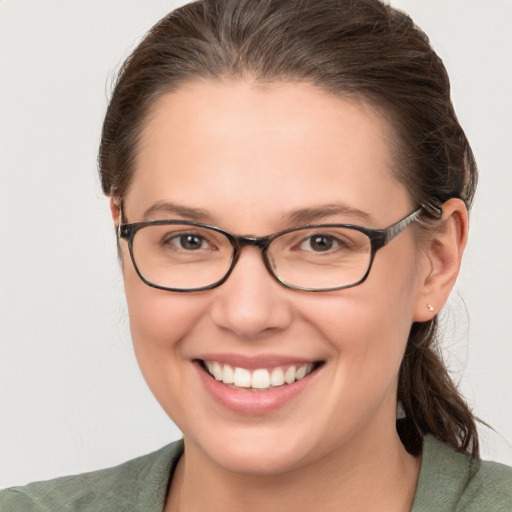 Joyful white young-adult female with medium  brown hair and grey eyes