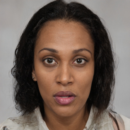 Neutral black young-adult female with medium  brown hair and brown eyes
