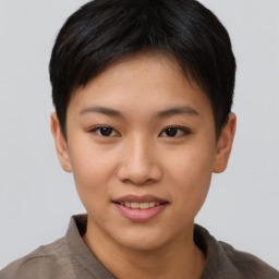 Joyful asian young-adult female with short  brown hair and brown eyes