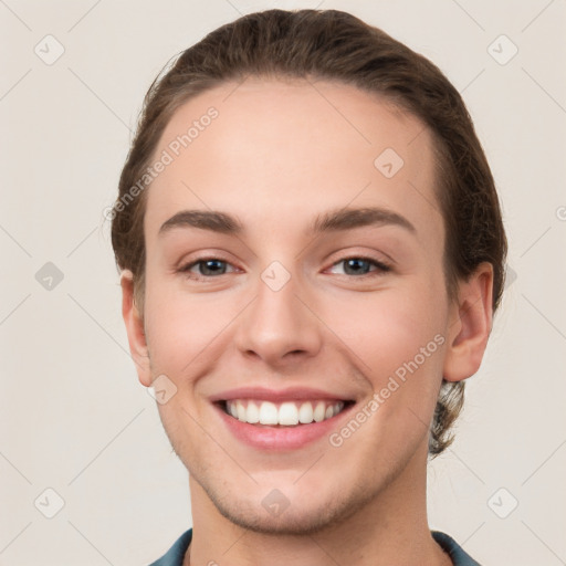 Joyful white young-adult female with short  brown hair and grey eyes