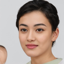 Joyful asian young-adult female with medium  black hair and brown eyes