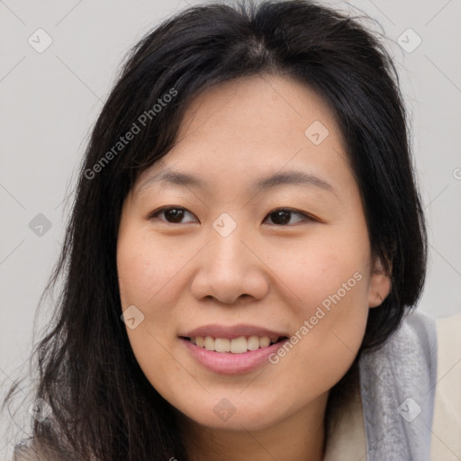 Joyful asian young-adult female with long  brown hair and brown eyes