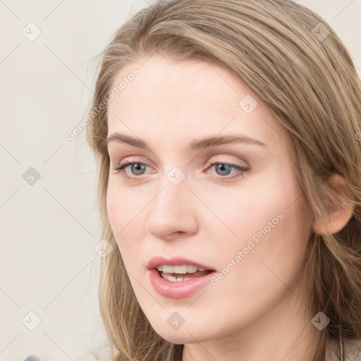 Joyful white young-adult female with long  brown hair and blue eyes