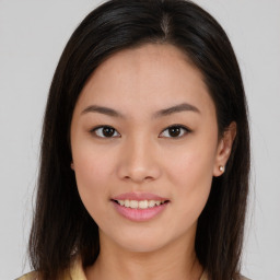 Joyful asian young-adult female with long  brown hair and brown eyes