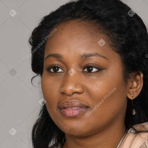 Joyful black young-adult female with long  black hair and brown eyes