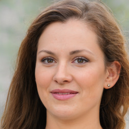 Joyful white young-adult female with long  brown hair and blue eyes