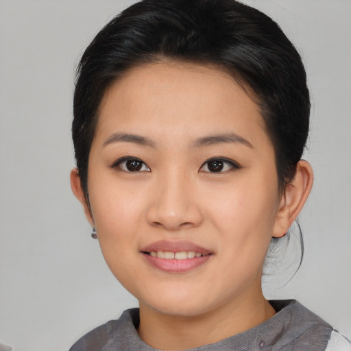 Joyful asian young-adult female with short  brown hair and brown eyes