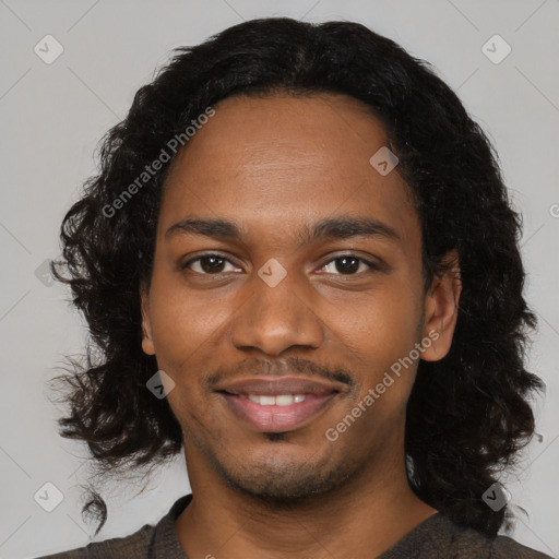 Joyful black young-adult male with medium  black hair and brown eyes