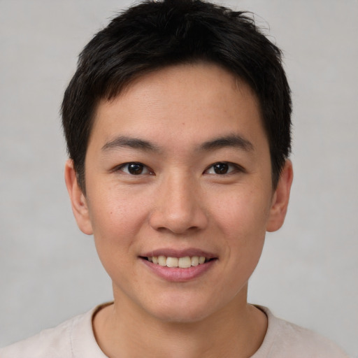Joyful asian young-adult male with short  brown hair and brown eyes