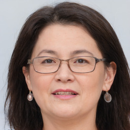 Joyful white adult female with long  brown hair and brown eyes